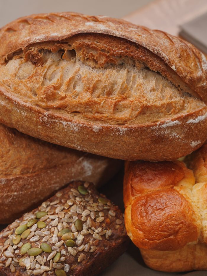 The Art of Drawing Readers In: Your attractive post title goes here Freshly baked artisanal breads including rye, brioche, and sourdough stacked together.